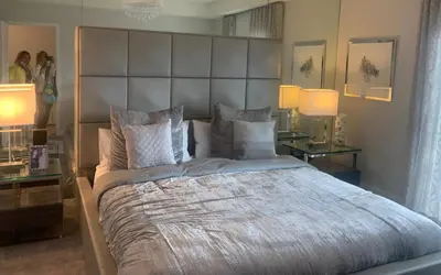 a bedroom with a large bed with a large headboard at Hotel Portolindo in Barranquilla