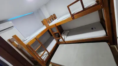 two bunk beds in a room with the top bunk at Cabaña brisa de mar in San Silvestre