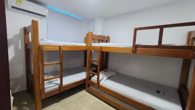 a room with three bunk beds in a room at Cabaña brisa de mar in San Silvestre