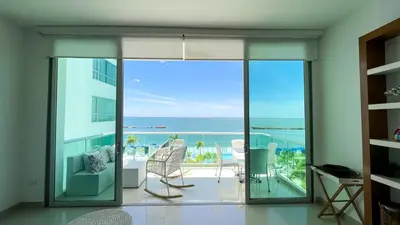 a living room with a view of the ocean at Magico Apartamento Frente al Mar 4 Habitaciones BM33 in Coveñitas