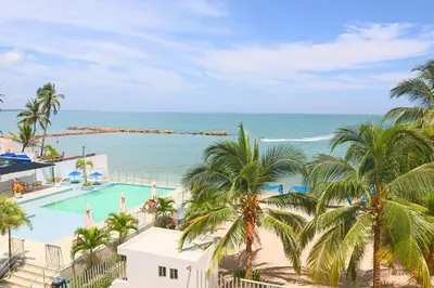 a view of the ocean from the balcony of a resort at Magico Apartamento Frente al Mar 4 Habitaciones BM33 in Coveñitas