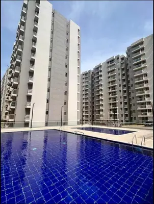 an empty swimming pool in front of two tall buildings at Apto Hermoso Samu in Barranquilla