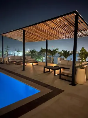 a pavilion with couches and a pool at night at Apartamento Moderno en Cartagena 1546 in Cartagena de Indias