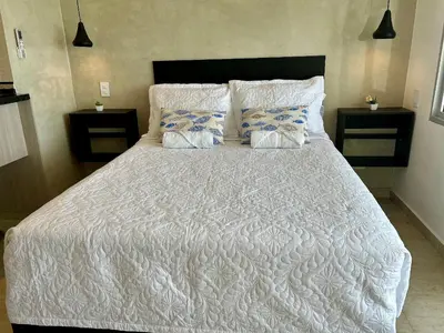 a bedroom with a white bed with two pillows at Suite con vista al mar Cartagena CB808 in Cartagena de Indias