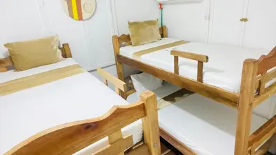 two bunk beds in a room with white walls at Apartamentos las palmas in Cartagena de Indias