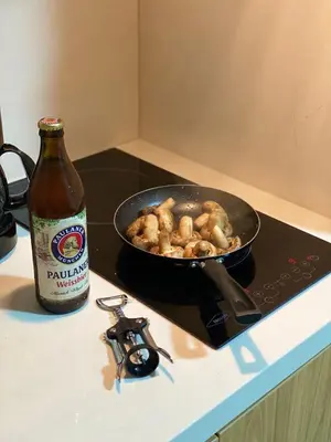 a frying pan on a stove with a pan of food at apartamento miniluxxury in Barranquilla