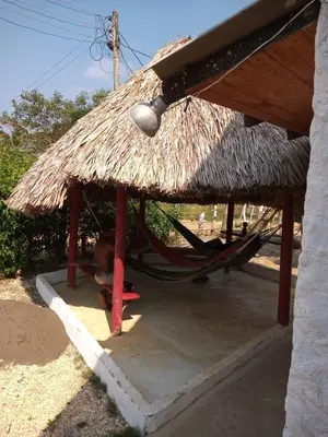 a straw hut with a hammock under it at Refugio olgamar, Cabaña con kiosco cerca al mar in Moñitos