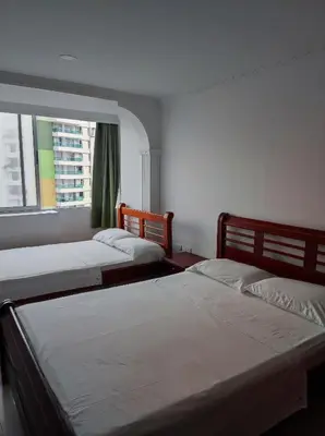 two beds in a room with a window at Cartagena Beach con vista al mar in Cartagena de Indias