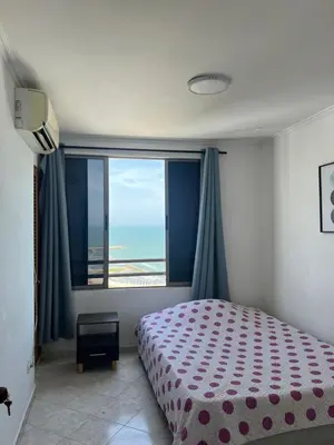 a bedroom with a bed and a large window at Mar del norte in Cartagena de Indias