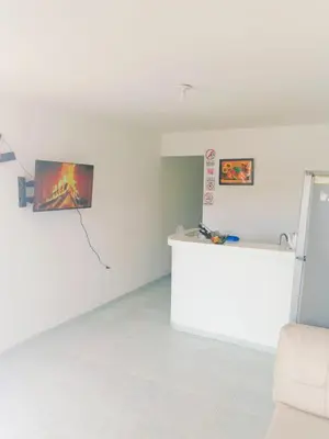 a white room with a counter and a refrigerator at Apartamento Acogedor Yenis House in Cartagena de Indias