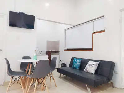 a living room with a black couch and a table at apto centro comodo 3 piso -- 1 in Cartagena de Indias