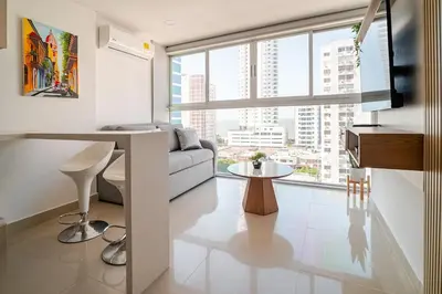 a living room with a couch and a large window at DUPLEX DE LUJO CON VISTA AL MAr in Cartagena de Indias