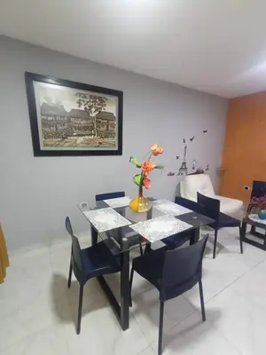 a dining room with a black table and chairs at Rincón Barranquilla CERCA DE TODO in Barranquilla