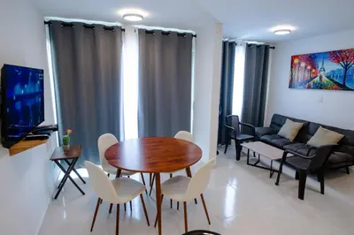 a living room with a table and chairs and a couch at Apartamento Cartagena Playa 2203 in Cartagena de Indias