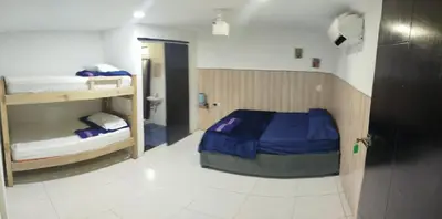 a room with a bed and bunk beds in it at casa perla del mar in Cartagena de Indias