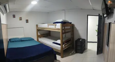 a small room with a bed and a bunk bed at casa perla del mar in Cartagena de Indias