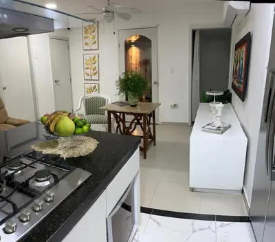 a kitchen with a sink and a stove top oven at Apartamento Vacacional en Bocagrande in Cartagena de Indias