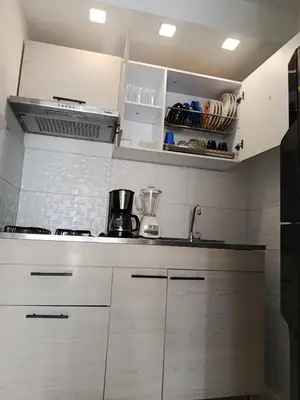 a kitchen with white cabinets and a counter top at Lindo apartamento in Cartagena de Indias