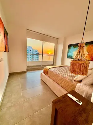 a large bedroom with a bed and a table at Hermoso apartamento con vista al mar in Santa Marta