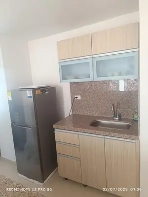 a kitchen with a sink and a refrigerator at Lajoya in Barranquilla