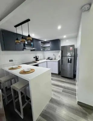 a kitchen with a white counter and a refrigerator at apartamento in Cartagena de Indias
