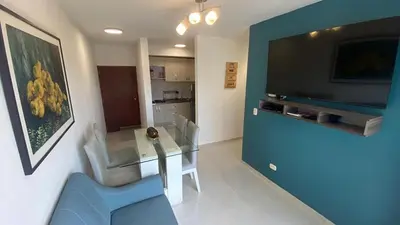 a living room with a glass table and a television at apartamento in Cartagena de Indias