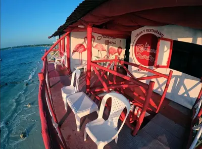 a red boat with chairs on the water at Machu Picchu - Barú in Playa Blanca