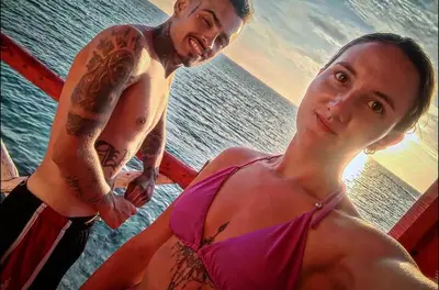 a man and a woman standing next to the water at Machu Picchu - Barú in Playa Blanca