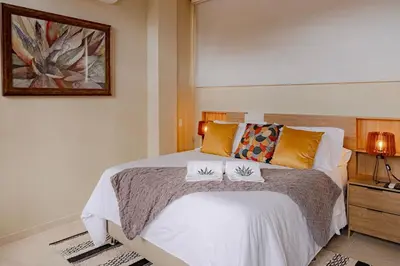 a bedroom with a bed with two pillows on it at Casa Maguey – Refugio Tropical en el Centro de Cartagena in Cartagena de Indias