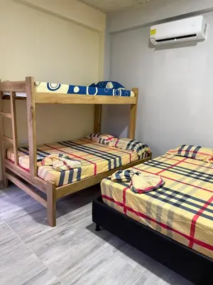 a room with two bunk beds and a fan at Villa Ana tu hogar lejos de casa in Coveñas
