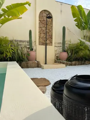 a patio with cactuses and plants and a building at Villa Privada con Piscina - Playas del Atlantico in Tubará