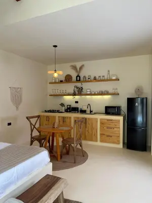 a bedroom with a kitchen with a table and a refrigerator at Villa Privada con Piscina - Playas del Atlantico in Tubará