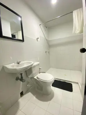 a white bathroom with a toilet and a sink at Apartamento Para 6 Pax En La Boquilla VIAMAR in Cartagena de Indias
