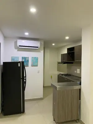 a kitchen with a black refrigerator and a sink at Apartamento Para 6 Pax En La Boquilla VIAMAR in Cartagena de Indias