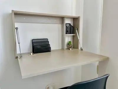 a white desk in a room with a chair at Relax with a views, massage chairs and coffee station in Barranquilla