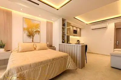 a bedroom with a large bed and a kitchen at Nueva, Lujosa y Exclusiva Suite Vista al Mar in Cartagena de Indias