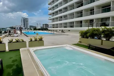 a large swimming pool next to a large building at Nueva, Lujosa y Exclusiva Suite Vista al Mar in Cartagena de Indias