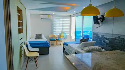 a room with a bed and a couch and a table at Apto Vista Laguito y Mar Piso 21 in Cartagena de Indias