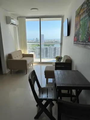 a living room with a table and chairs and a window at VISTA CARIBE- apartamento piso 25, marbella in Cartagena de Indias