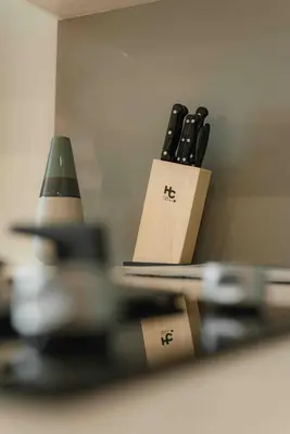 a group of knives in a holder in front of a mirror at Suite 1010 - Ocean View - Distrito90 in Barranquilla