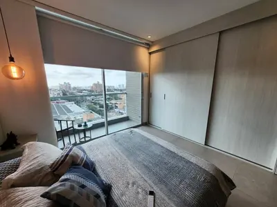 a bedroom with a large bed and a large window at Suite 1010 - Ocean View - Distrito90 in Barranquilla