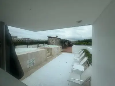 a group of white chairs sitting on top of a building at Incredible 2BR with AC in Ciudad Amurallada in Cartagena de Indias