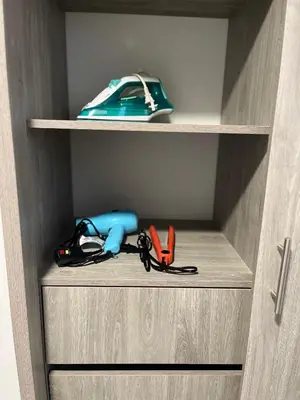 a wooden cabinet with some items in it at Alojamiento Nuevo en Piso 24 con WiFi Rápido y Vista al Mar, Cerca al Centro Histórico in Cartagena de Indias