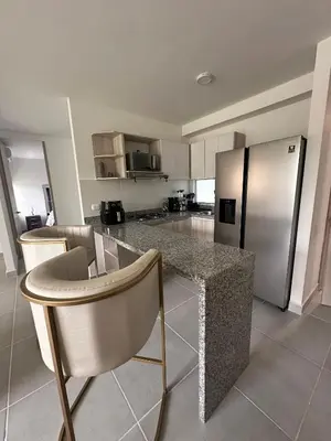 a kitchen with a counter and a stainless steel refrigerator at Cartagena Vibes-Apartamento Serena del Mar in Cartagena de Indias