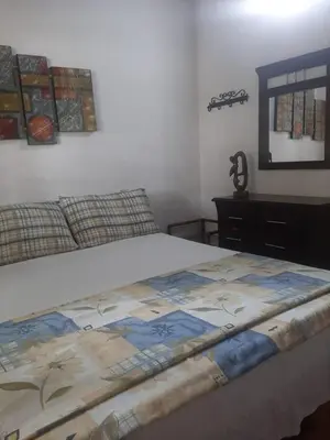 a bedroom with a bed and a dresser at Victoria Real in Coveñas