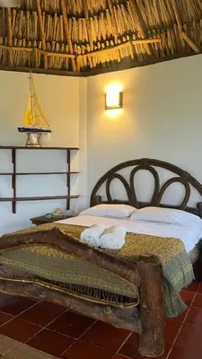 a bedroom with a bed with towels on it at Punta Manzanillo in San Bernardo del Viento