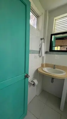 a bathroom with a sink and a blue door at Punta Manzanillo in San Bernardo del Viento