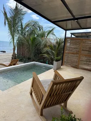 a swimming pool with a bench and a table at Luxury Suite frente de Mar Piscina Restaurante y Bar in San Silvestre