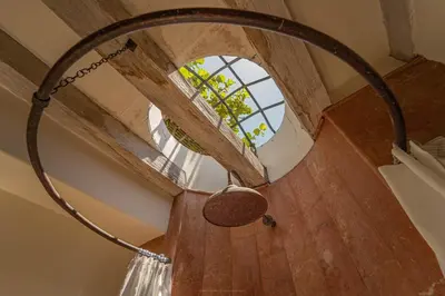 a spiral staircase with a circular window in a house at Niña Maria pool House Plaza San Diego, Downtown! in Cartagena de Indias
