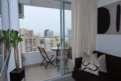a living room with a couch and a table on a balcony at Piso 32 Vista al mar y centro histórico in Cartagena de Indias